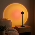 Sunset projection lamp casting a warm golden-hour sunset circle on a bedroom wall at night — USB mood light by Kiroa